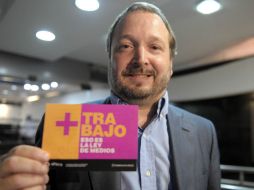 Funcionario muestra un panfleto con una leyenda a favor de Ley de Medios. XINHUA  /