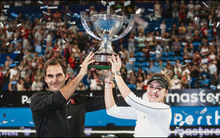 La pareja suiza conformada por Roger Federer y Belinda Bencic levanta el trofeo de campeón tras vencer en la Final a la dupla alemana. EFE