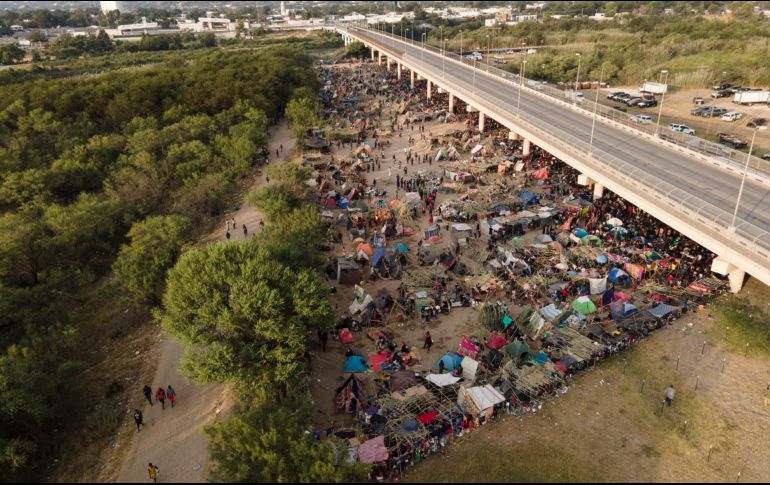 Migrantes, la mayoría de Haití, se ven hoy en el campamento improvisado junto al puente internacional en Del Río, Texas, cerca del río Bravo. AP/J. Cortez