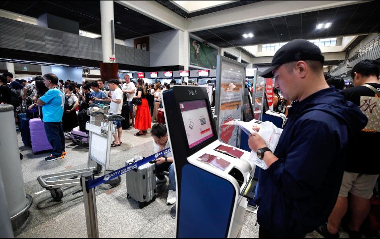 Un hombre trata de registrarse en el aeropuerto Don Mueang, en la capital de Tailandia. EFE/R. Yongrit