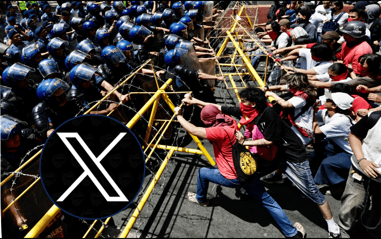 En Manila, Filipinas, manifestantes intentan retirar una barrera ante la policía antidisturbios durante la manifestación del Día Internacional del Trabajo, este jueves. EFE / F. R. MALASIG