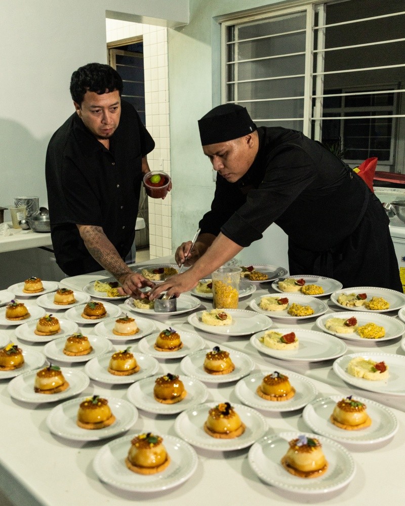 El chef Óscar Garza y Gregorio, del Restaurante Bruna, montan los platos para los usuarios del albergue CADIPSIC