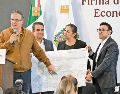 Marcelo Ebrard señala un plano con la distribución que tendrá el clúster en Puebla, que también impulsará la vivienda en la zona. ESPECIAL
