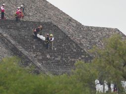 Forenses bajan el cadáver de una víctima por una pirámide después de que un hombre armado abriera fuego en Teotihuacán. AP/E. Verdugo